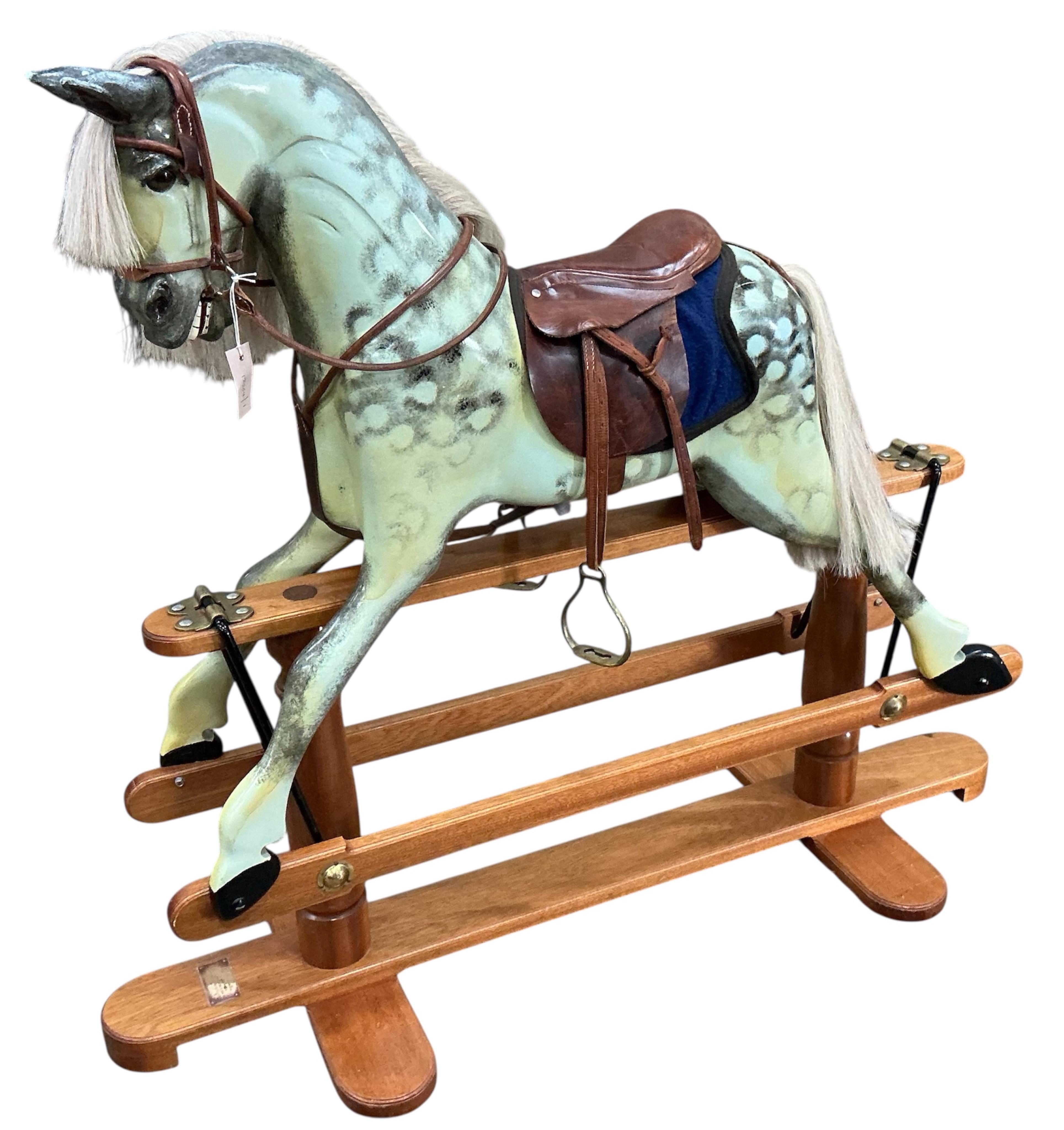 A modern Robert Mullis of Swindon dapple grey rocking horse with tan leather tack on mahogany safety frame, height 116cm